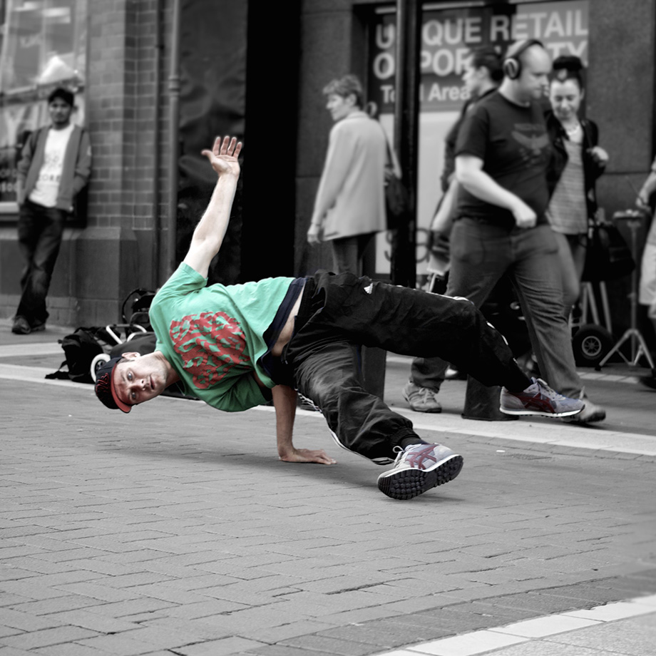 Break dancer holding pose in street